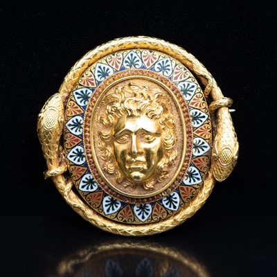 Lot 69 - A late 19th Century yellow metal and enamel oval brooch, with a central mask in high relief.