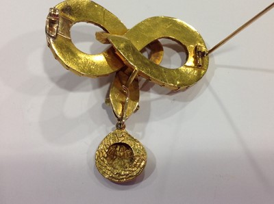 Lot 68 - A mid 19th Century yellow metal brooch, in the form of a coiled snake with simulated scales