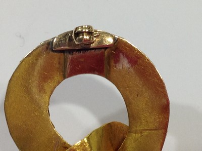 Lot 68 - A mid 19th Century yellow metal brooch, in the form of a coiled snake with simulated scales