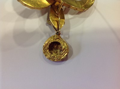 Lot 68 - A mid 19th Century yellow metal brooch, in the form of a coiled snake with simulated scales