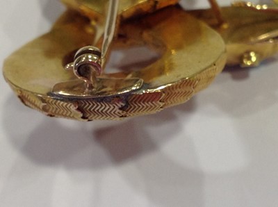 Lot 68 - A mid 19th Century yellow metal brooch, in the form of a coiled snake with simulated scales