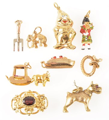 Lot 99 - Eight various gold and yellow metal charms and a necklace fastener