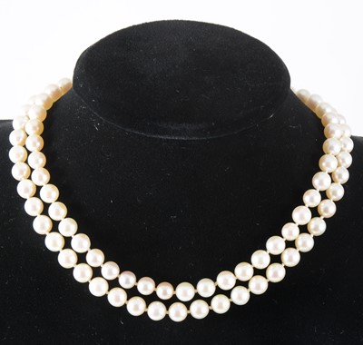 Lot 126 - A two row cultured pearl necklace with amethyst fastener.