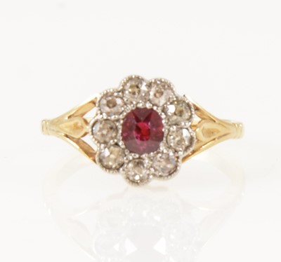 Lot 25 - A ruby and diamond cluster ring.