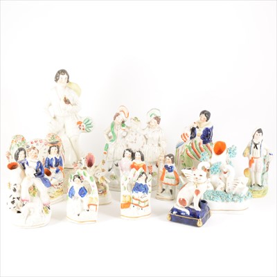 Lot 39 - A collection of thirteen Staffordshire figures, spill vases, and pen stands