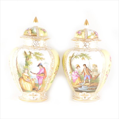 Lot 12 - A pair of continental lidded vases.