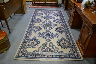 Lot 494 - A Turkey long rug, formal medallions on a fawn coloured field