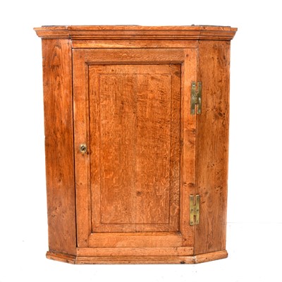 Lot 70 - George III oak hanging corner cupboard