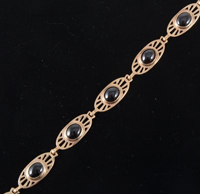 Lot 92 - A 9 carat rose gold garnet set bracelet.