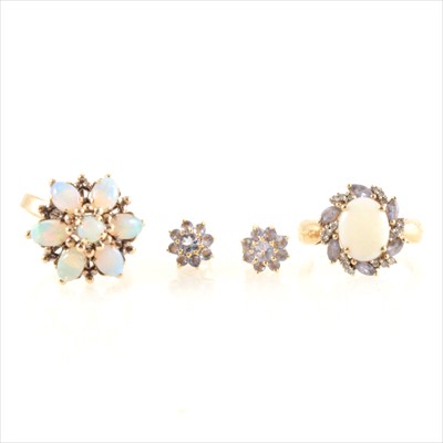 Lot 197 - Two opal dress rings and a pair of tanzanite earrings.