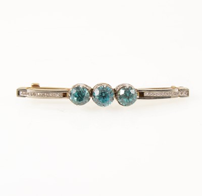 Lot 1290 - A heat treated blue zircon and diamond brooch.