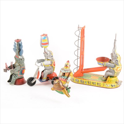Lot 440 - Tin-plate circus clock-work toys; four including T.A.S Japan clown with lion, 13cm, and three elephant toys.
