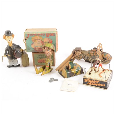Lot 439 - Tin-plate clock-work toys; seven to include Slugger Champions etc