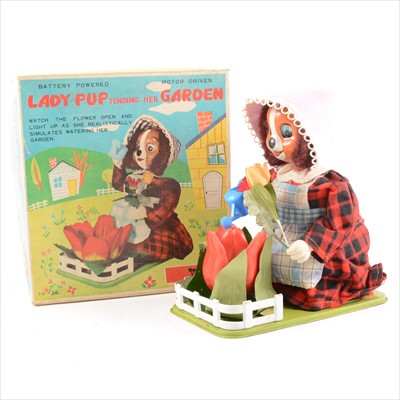 Lot 433 - Tomiyama battery operated tin-plate and plastic Lady Pup Tending Her Garden, 19cm long, boxed.