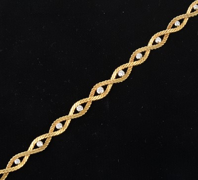 Lot 84 - An 18 carat yellow gold bracelet set with eleven diamonds.