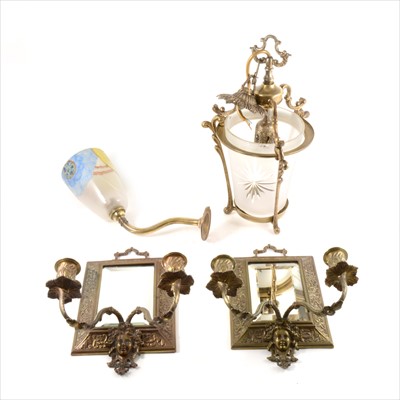 Lot 99 - A pair of Edwardian cast brass two-light girandoles...