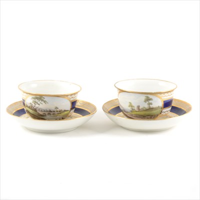 Lot 8 - A pair of Derby style porcelain breakfast cups and saucers, with named views, Nr Caernarfon, South Wales