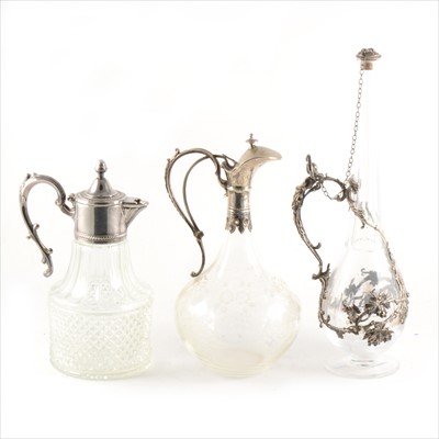 Lot 90 - A German silver mounted claret jug,, another claret jug with white metal mounts...