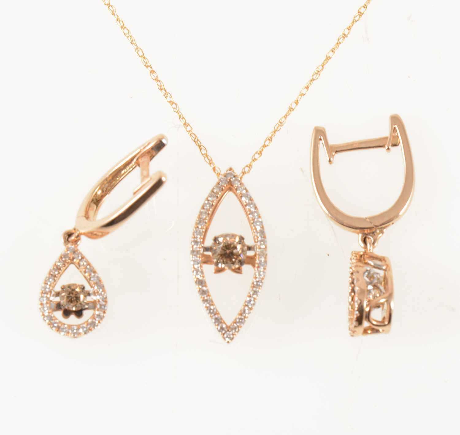 Lot 51 - A dancing diamond pendant and pair of matching earrings.