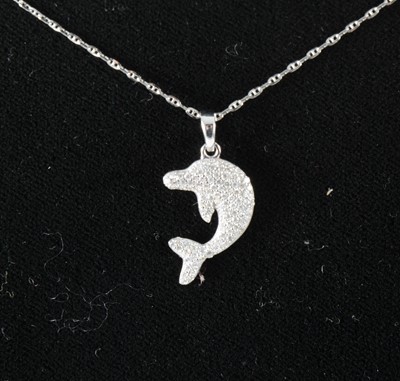 Lot 121 - A diamond set dolphin pendant.