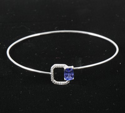 Lot 97 - A delicate tanzanite and diamond bangle.