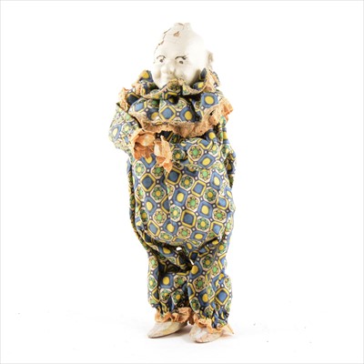 Lot 74 - A wind-up clockwork clown in costume, wood and painted cardboard composition.
