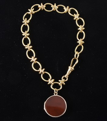 Lot 90 - An 18 carat yellow gold link bracelet with fob attached.