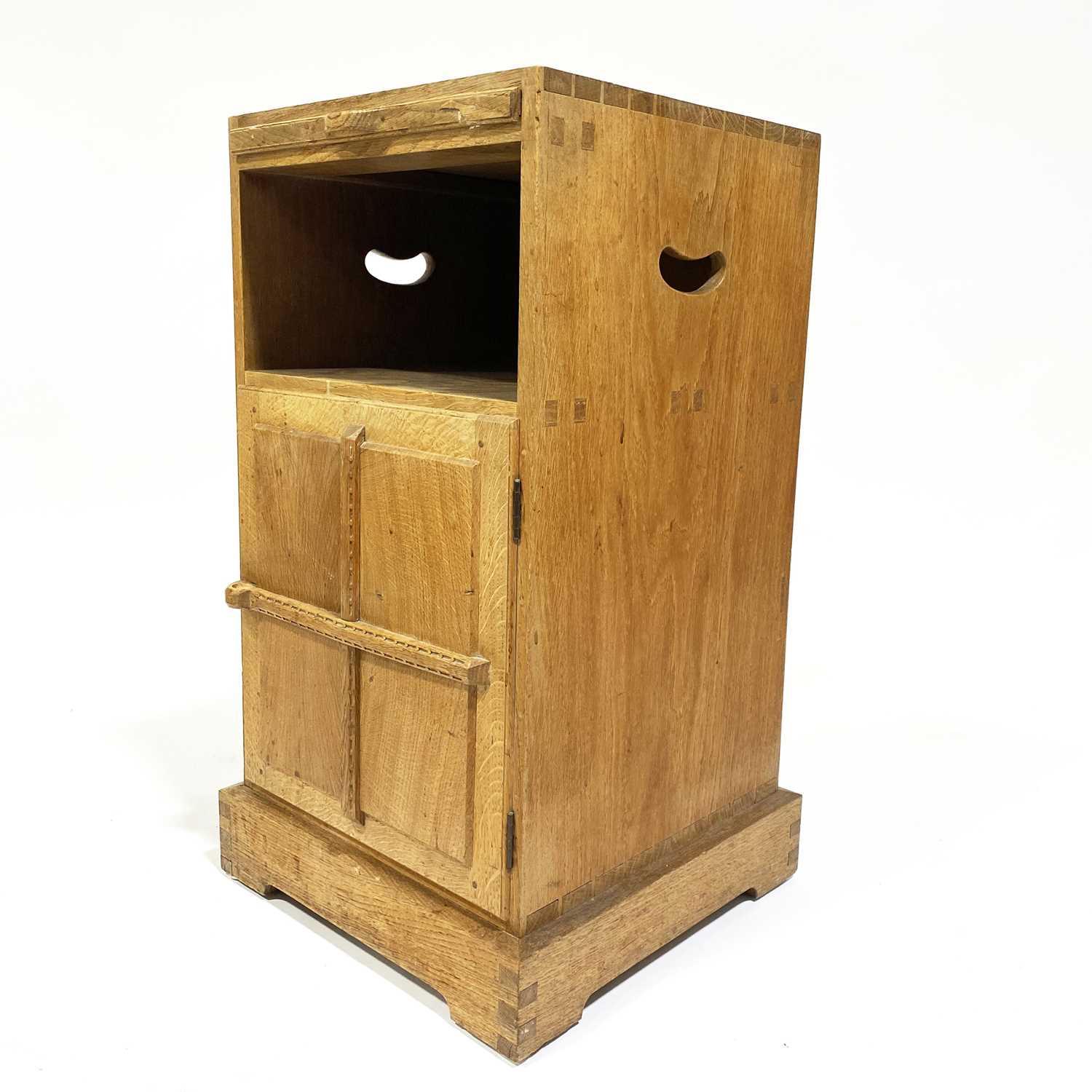 Lot 534 - An Arts and Crafts oak bedside pedestal cupboard, by Peter van der Waals for Claude Biddulph