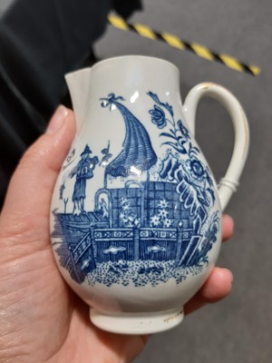Lot 16 - A Caughley blue and white sparrow beak jug and a First Period Worcester tea caddy