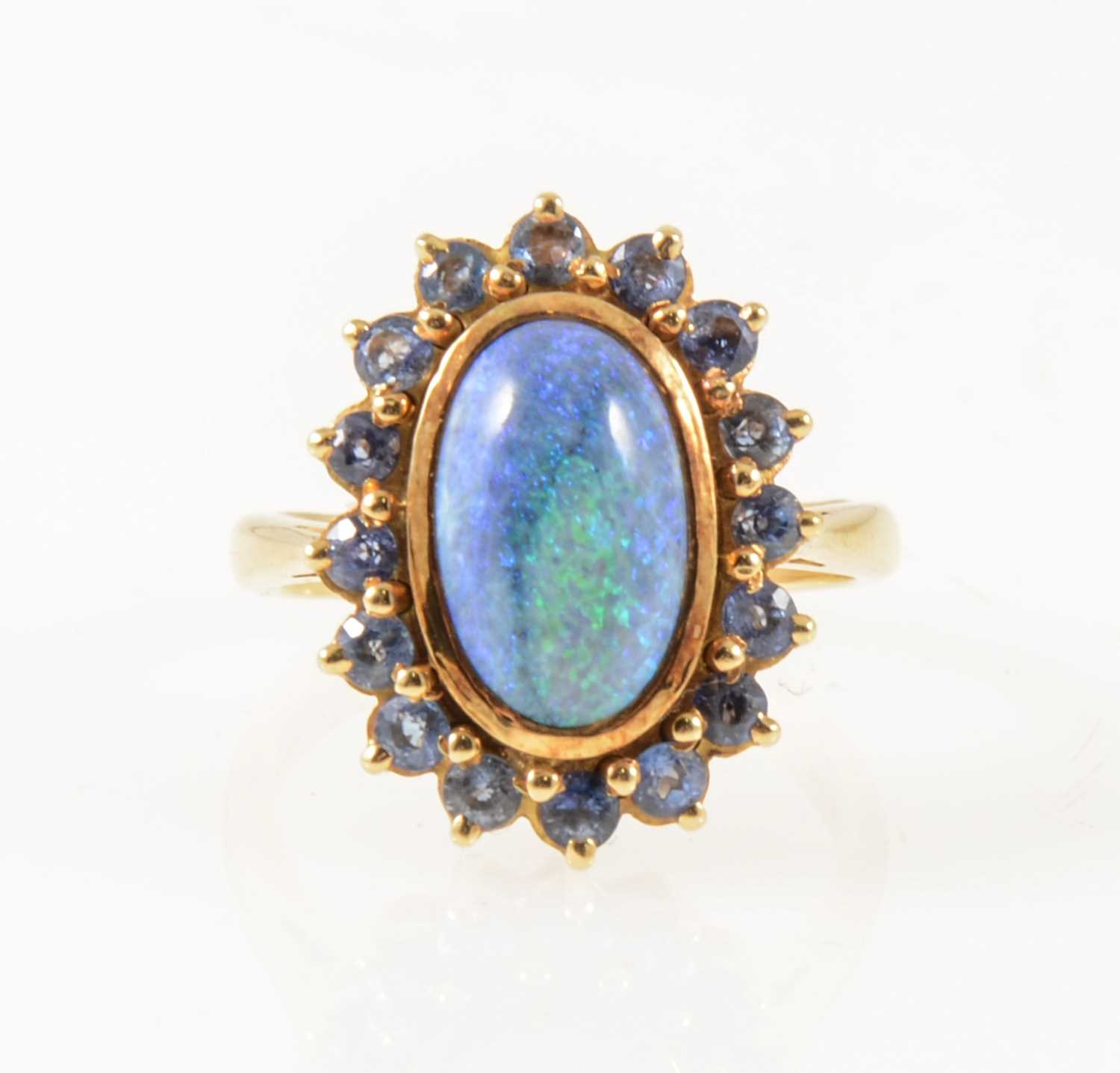 Lot 38 - A black opal and sapphire dress ring.