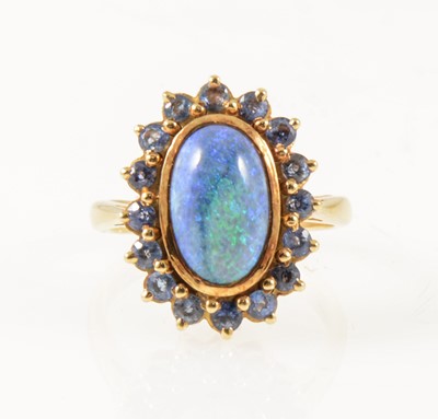 Lot 38 - A black opal and sapphire dress ring.
