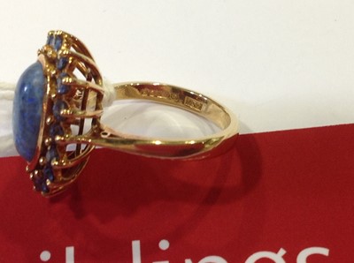 Lot 38 - A black opal and sapphire dress ring.