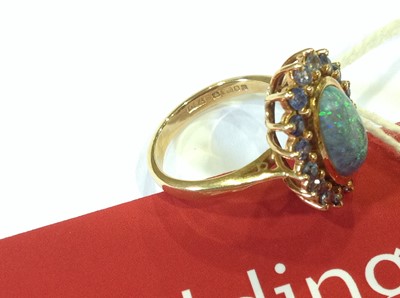 Lot 38 - A black opal and sapphire dress ring.
