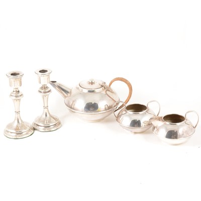 Lot 189 - A pair of silver-filled 16cm candlesticks, a silver plated three-piece teaset by Plato.