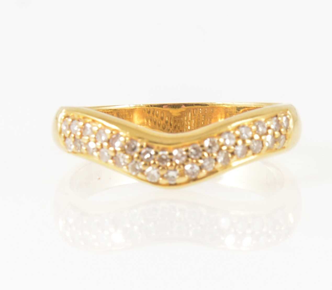 Lot 17 - A diamond set wishbone ring.