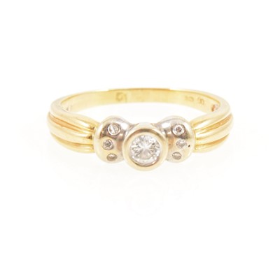 Lot 1254 - A diamond solitaire ring with three diamonds set into each shoulder.