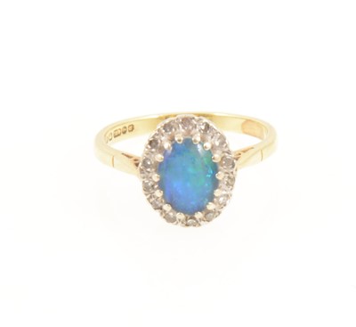 Lot 1267 - An opal triplet oval cluster ring.