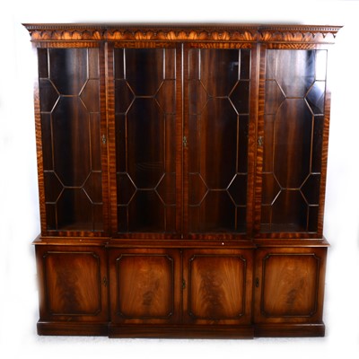 Lot 120 - A reproduction mahogany breakfront bookcase, George III style