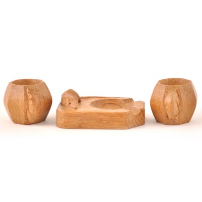 Lot 595 - Robert 'Mouseman' Thompson of Kilburn, a pair of carved oak napkin rings, and an ashtray