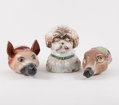 Lot 14 - Two Staffordshire mask stirrup cups and a novelty tobacco box