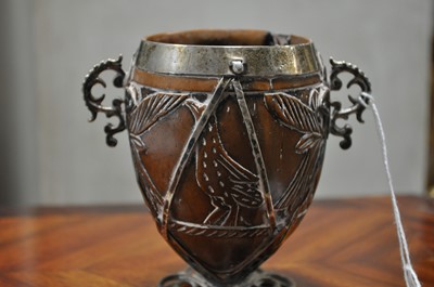 Lot 90 - A white metal mounted coconut cup of ovoid form, pricked date 1590