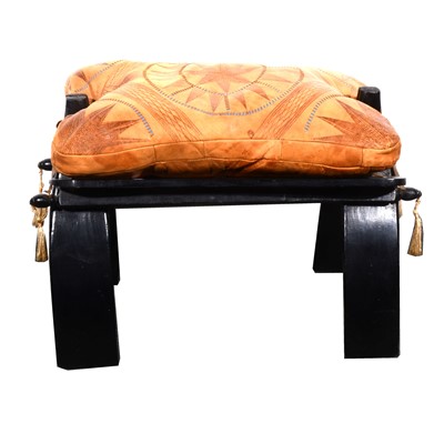 Lot 169 - A North African ebonised camel stool