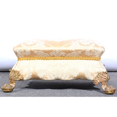 Lot 416 - An upholstered footstool, on cast brass lion paw feet