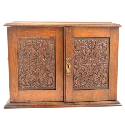 Lot 113 - An Edwardian oak smokers cabinet