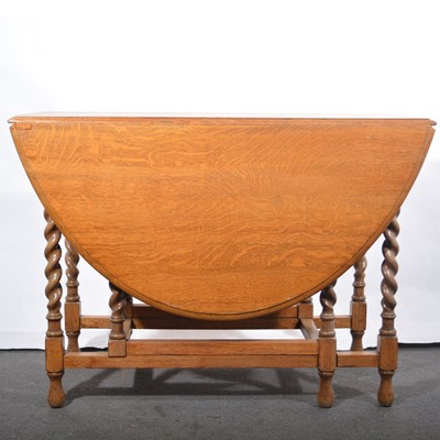 Lot 217 - Light oak gateleg dining table.