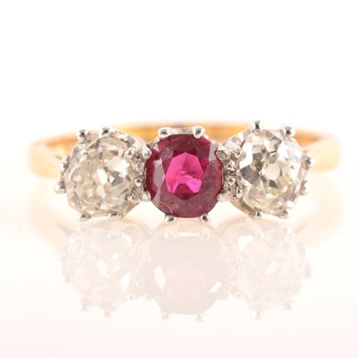 Lot 225 - A ruby and diamond three stone ring.