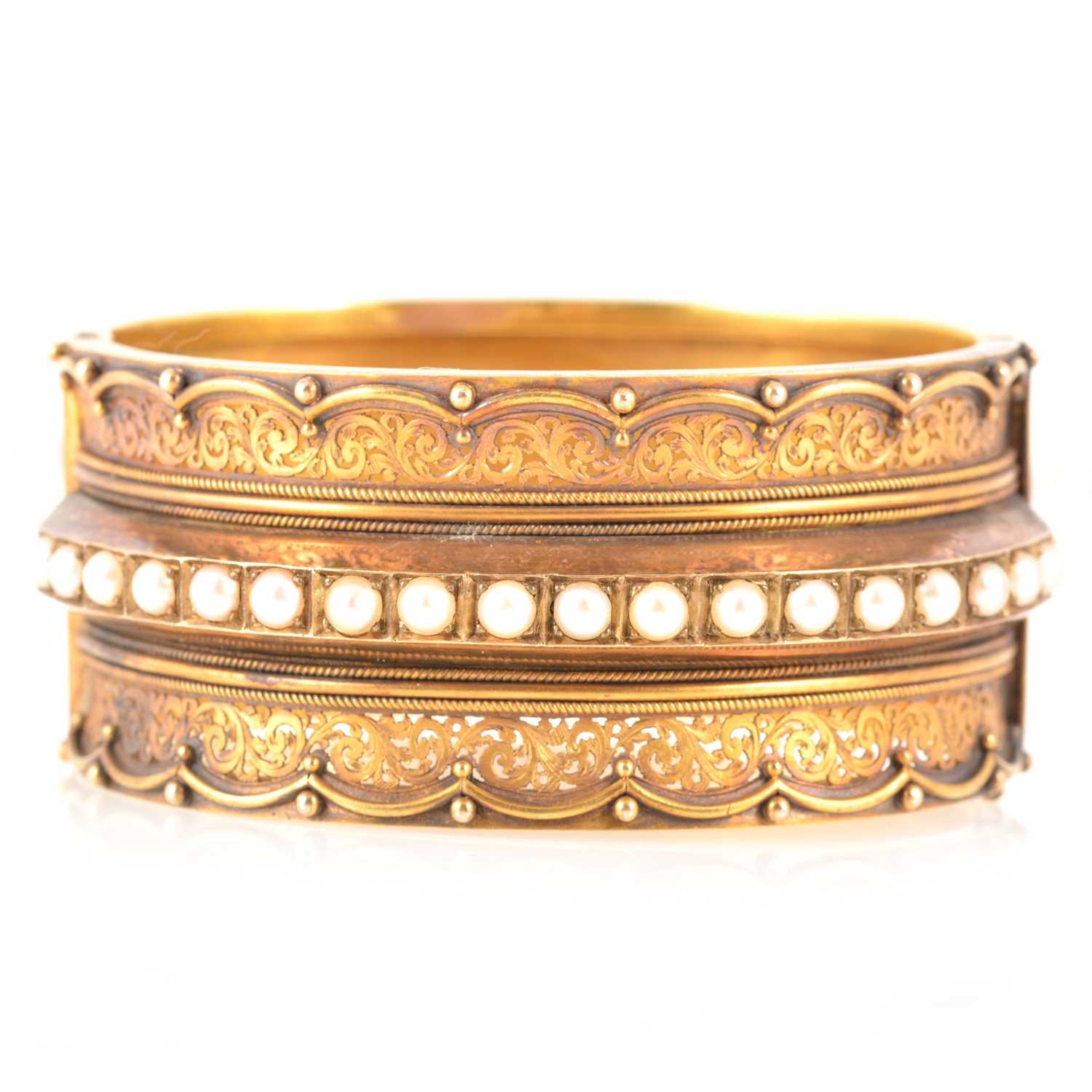 Lot 212 - A Victorian yellow metal half hinged bangle set with pearls.