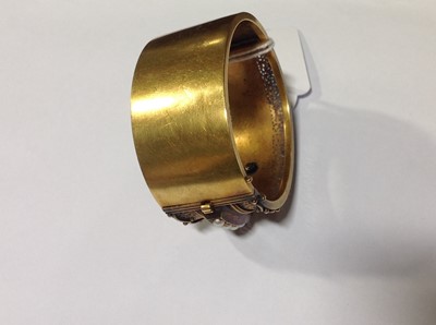 Lot 212 - A Victorian yellow metal half hinged bangle set with pearls.