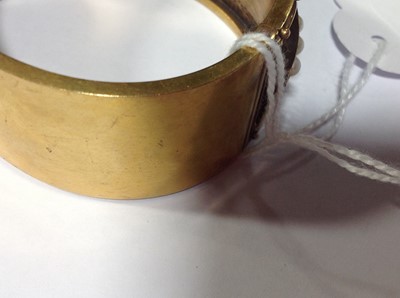Lot 212 - A Victorian yellow metal half hinged bangle set with pearls.