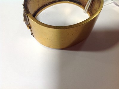 Lot 212 - A Victorian yellow metal half hinged bangle set with pearls.